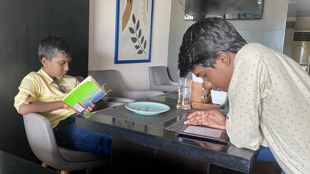 Boys reading on a 'reading hours' Boys reading on a "reading hours"